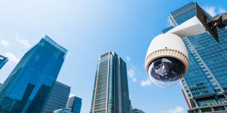 Onderaanzicht van beveiligingscamera met wolkenkrabbers op de achtergrond