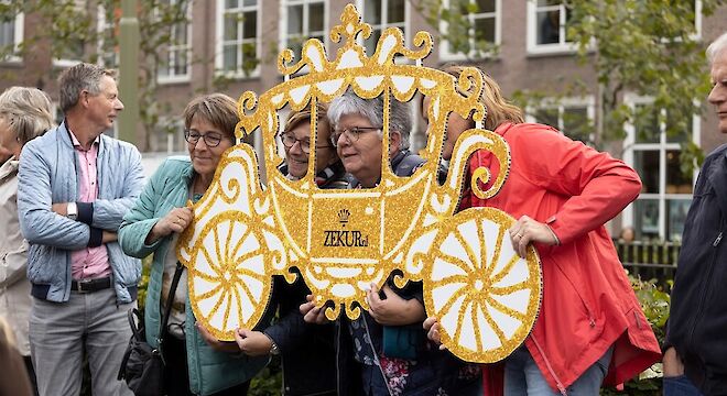 vrouwen in zelfgemaakte gouden koets van karton